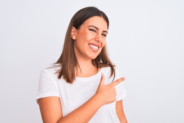 Portrait of beautiful and young brunette woman standing over isolated white background cheerful with a smile of face pointing with hand and finger up to the side with happy and natural expression