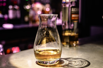 Flight of Scottish whisky, tasting glasses with variety of single malts or blended whiskey spirits on distillery tour in pub in Scotland