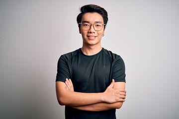 Young handsome chinese man wearing black t-shirt and glasses over white background happy face...