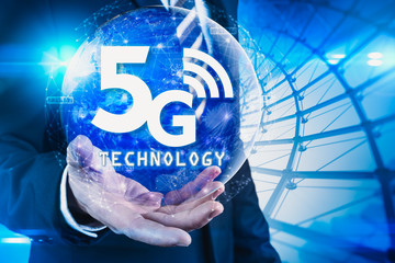 The abstract image of businessman using a smartphone overlay with 5g and cityscape hologram. the concept of 5G, communication, network, connection, internet of things.