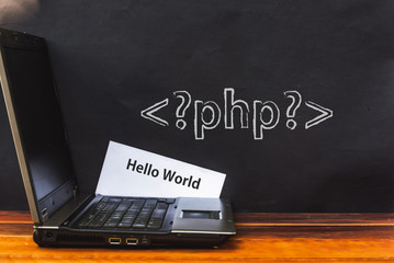 PHP programming language. laptop and php tag on dark wall