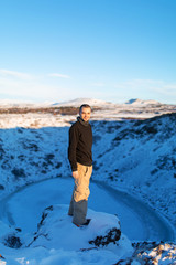 The guy near the frozen lake kerid in the crater of the volcano. Wonderful Iceland in the winter