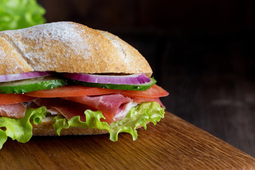 Fresh and tasty sandwich on wooden board