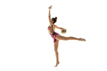 Obraz premium Young flexible girl isolated on white studio background. Teen-age female model as a rhythmic gymnastics artist practicing with equipment. Exercises for flexibility, balance. Grace in motion, sport.