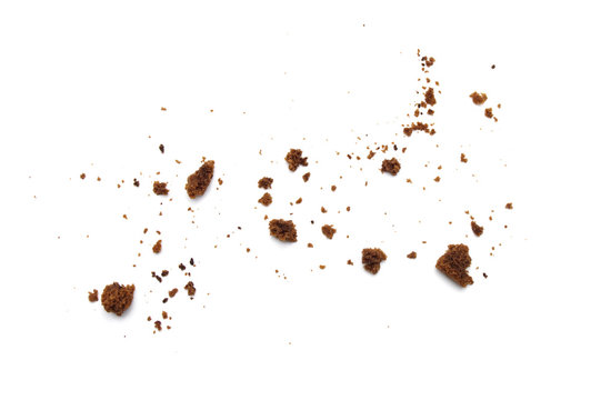 Scattered crumbs of chocolate chip cookies isolated on white background.