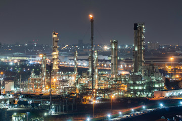 Fototapeta na wymiar Oil refinery factory and oil storage tank at twilight and night. Petrochemical Industrial