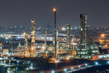 Oil refinery factory and oil storage tank at twilight and night. Petrochemical Industrial