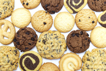 A group of assorted cookies. Chocolate chip, oatmeal, raisin, Danish cookies and biscuits in the shape of a spiral pattern close-up on full frame background.