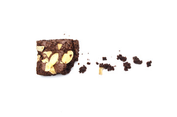 Chocolate brownie with sliced almond nuts toppings crumbs isolated on white background.