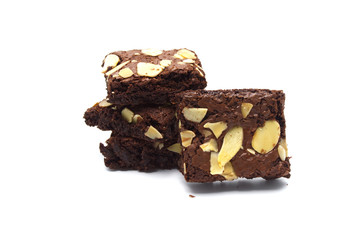 Pile of chocolate brownies with sliced almond nuts toppings isolated on white background.