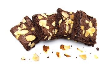 Pile of chocolate brownies with sliced almond nuts toppings broken and crumbs isolated on white background.