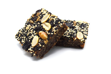 Homemade bread and bakery brownie, cake topped with groundnuts raisins sun flower seeds white and black sesame seeds on a white background.