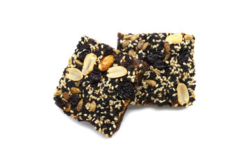 Fototapeta na wymiar Homemade bread and bakery brownie, cake topped with groundnuts raisins sun flower seeds white and black sesame seeds isolated on white background. Top view photograph.