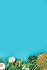 Tropical summer background with tropical palm leaves and coconuts, trendy turquoise, aquamarine...