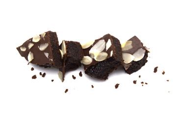 Pile of chocolate brownies with sliced almond nuts toppings broken and crumbs isolated on white background.