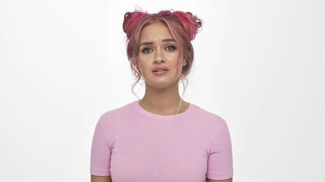 A sick young woman with the colored pink hairstyle is coughing while having a sore throat isolated over white background