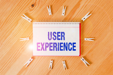 Handwriting text writing User Experience. Conceptual photo the overall experience of a demonstrating using a product Colored clothespin papers empty reminder wooden floor background office