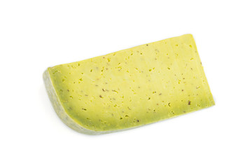 Piece of green cheese with basil isolated on white background. Top view.