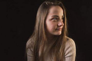 impulsive girl with light hair on a dark background, portrait of a girl with large facial features