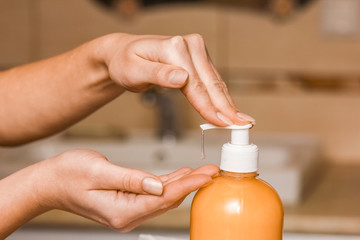 A Washing hands with soap under the faucet with water