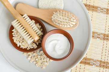 Fresh greek yogurt, oatmeal, wooden hairbrush and body brush. Natural skin care and zero waste concept. Top view, copy space