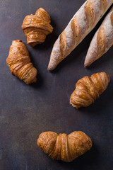 fresh croissant  and baguettes on a stone table