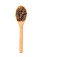 Spice allspice in wooden spoon isolated on white