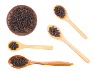 Set of spice black pepper in wooden spoon and clay plate isolated on white