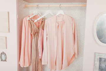 wooden pink wardrobe for women’s clothes, open doors, decor, mirror, bag, hangers, silk dresses...