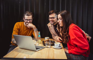 Young People at Fast Food Restaurant looking at Laptop	