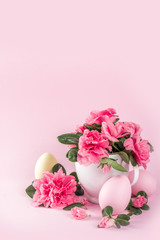 Tender Easter composition with easter eggs and pink spring flower branches