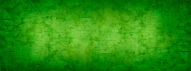 Abstract green yellow background for design. Toned old stained wood. Gradient. Light spot. Vintage. Wide banner. Panoramic. Copy space. Top view. 