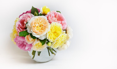 Bouquet of flowers  on white background. Roses on glass round vase, celebration concept
