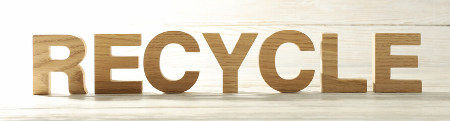 Recycle made of wooden letters on wood background, space for text