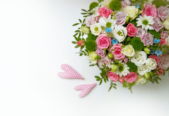 Bouquet of flowers with two hearts on white background
