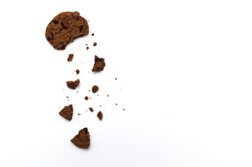 Chocolate chip cookies with some broken and crumbs on white background in Top view.