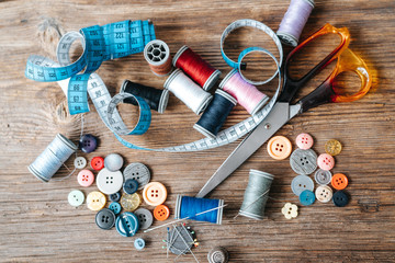 Top view of objects about Sewing equipment set on a wooden background. Sewing and tailoring concept.