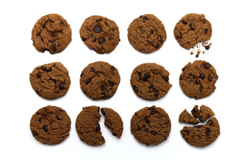 Set of chocolate chips cookies. Some broken and crumbs on white background in top view.