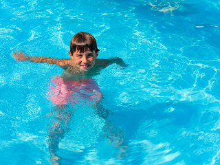 Child playing in the swimming pool