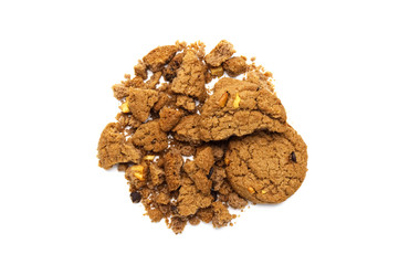 Cookies with chocolate chip flavored. Some broken and crumbs of crunchy delicious sweet meal and useful biscuits on white background.