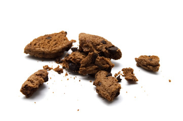Cookies with chocolate chip flavored. Some broken and crumbs of crunchy delicious sweet meal and useful biscuits on white background.