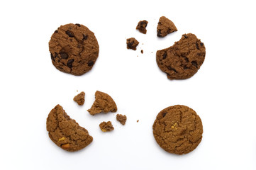 Chocolate chip cookies and crumbs on white background and Top view.