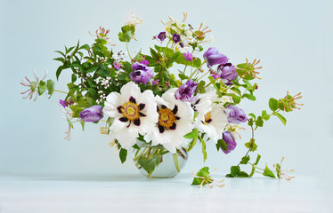 Bouquet of white peonies and purple tulips in glass  vase on white background, cover design, greeting card