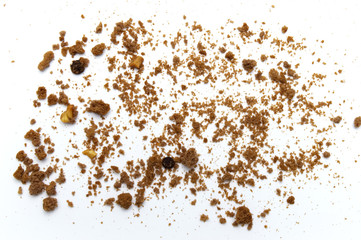 Scattered crumbs of chocolate chip cookies on white background.