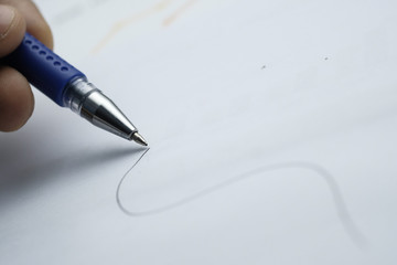 Close up of man hand writing on paper, signature 