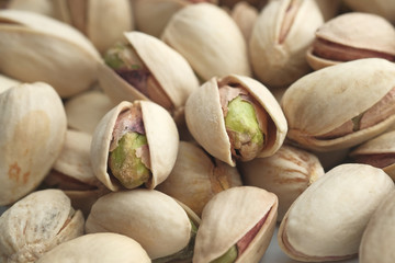 Close up of many baked pistachios on table 
