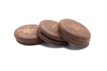 Chocolate sandwich cookies filled and coated with chocolate cream isolated on white background.