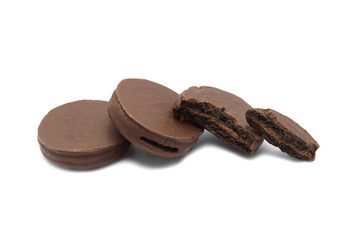 Chocolate sandwich cookies filled and coated with chocolate cream isolated on white background.