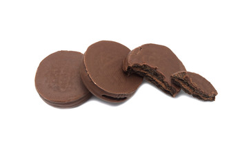 Chocolate sandwich cookies filled and coated with chocolate cream isolated on white background.