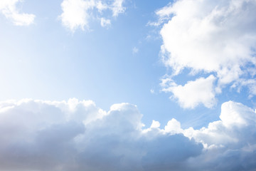 Blue sky with clouds and sunlight in daylight, soft bright background
